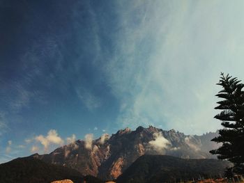 Low angle view of mountain against cloudy sky