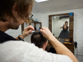 Rear view of man and woman holding camera