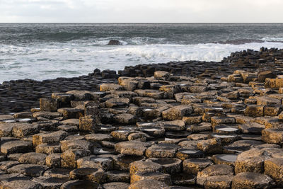 Aerial view of rocks on beach against sky