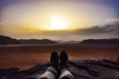 Low section of man at sunset