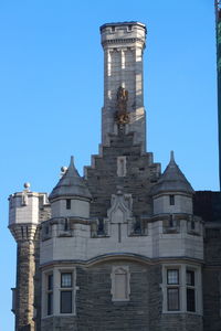 Low angle view of old building against blue sky