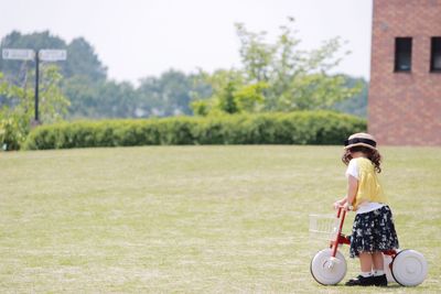 Girl playing on grassy field