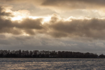 Scenic view of sea against cloudy sky