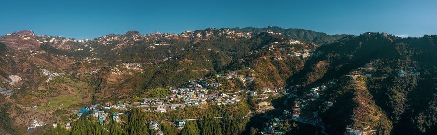 Panoramic view of trees and mountains against clear sky