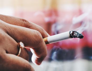 Cropped hand of woman holding cigarette