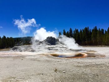 Hot spring on landscape against sky