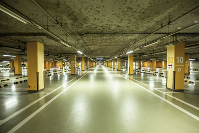 Empty illuminated walkway in building