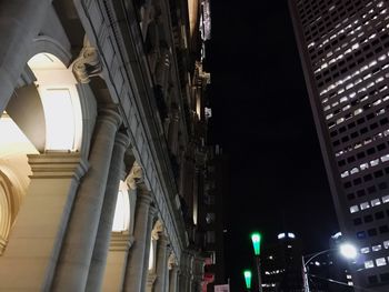 Low angle view of modern buildings against sky at night