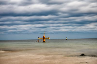 Lifeguard hut on beach against sky