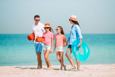 People on beach against sky