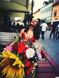 Woman standing by flower bouquet