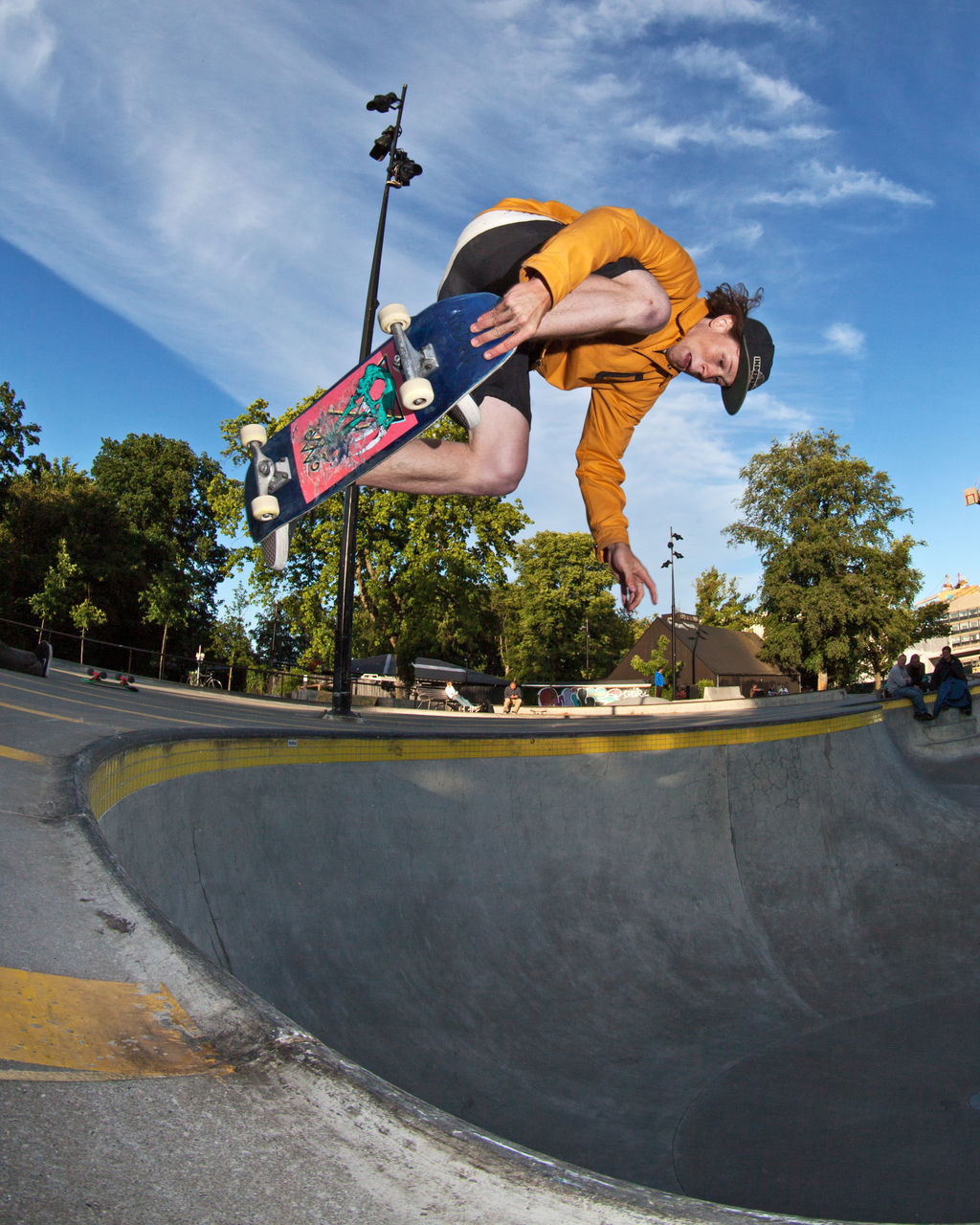 MAN SKATEBOARDING ON SKATEBOARD PARK