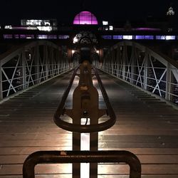 Illuminated bridge at night