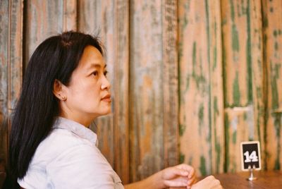 Side view of woman sitting at restaurant