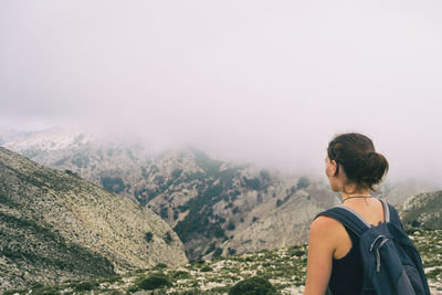 Woman hiking on a mountain path in catalonia on a cloudy summer day