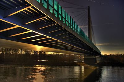 View of bridge over river at night