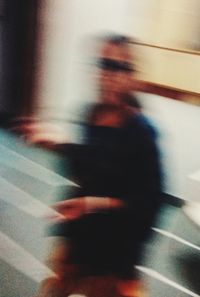 Defocused image of people walking in bus