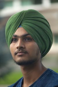 Close-up of young man with turban looking away