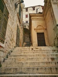 Low angle view of staircase in city against sky