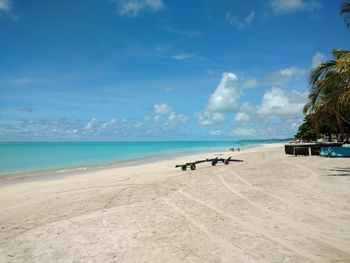 Scenic view of beach against blue sky