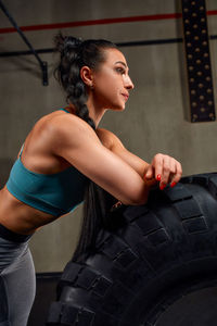 Side view of woman exercising in gym