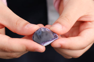 Close-up of person holding shell in hands