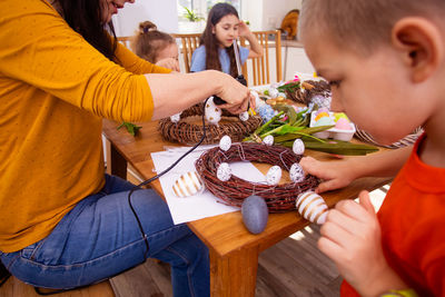 High angle view of mother and son on table