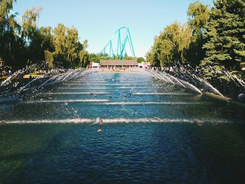 Fountain in park against sky