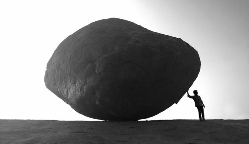 Close-up of person standing against sky