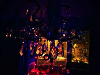 Illuminated candles in glass at night