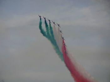 Low angle view of airplane flying against sky