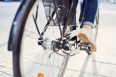 Low section of person with bicycle on street