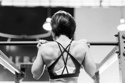 Rear view of woman standing by railing