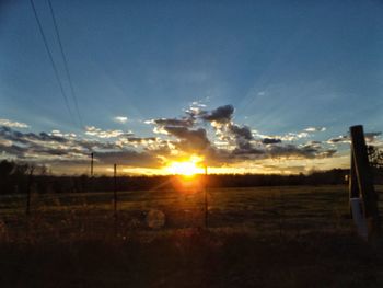 Scenic view of field against sky during sunset