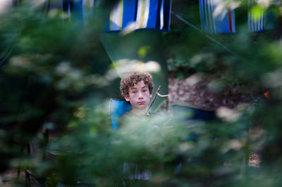 Boy sitting outdoors