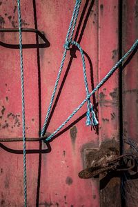 Close-up of rusty metal chain against wall