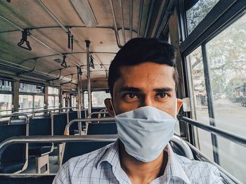 Portrait of young man in train