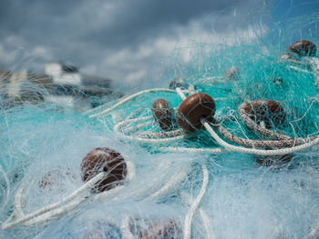 Close-up of fishing net on sea shore