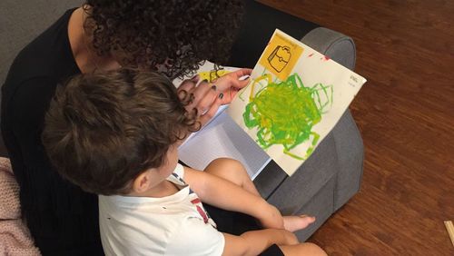 High angle view of siblings sitting on table