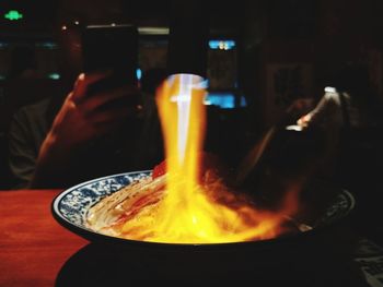 Close-up of lit candles on table in restaurant