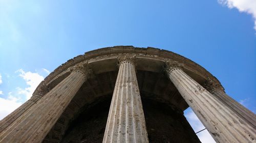 Low angle view of old building against blue sky