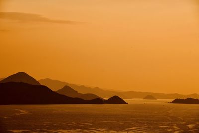 Scenic view of sea against orange sky