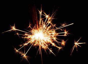 Low angle view of firework display against sky at night