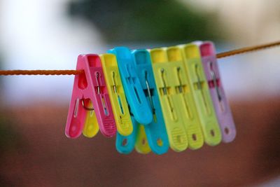 Close-up of colorful clothespins hanging on clothesline