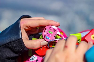 Close-up of woman holding multi colored hands