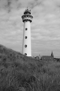 Low angle view of lighthouse against cloudy sky