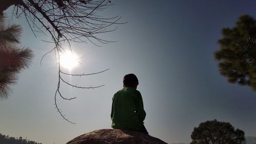 Rear view of silhouette man against sky during sunset