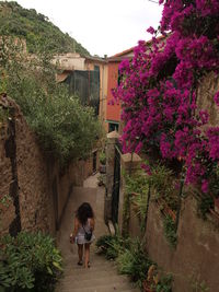 Woman standing by flowers