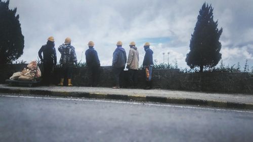 People standing on snow against sky