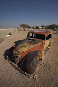 Abandoned car on field